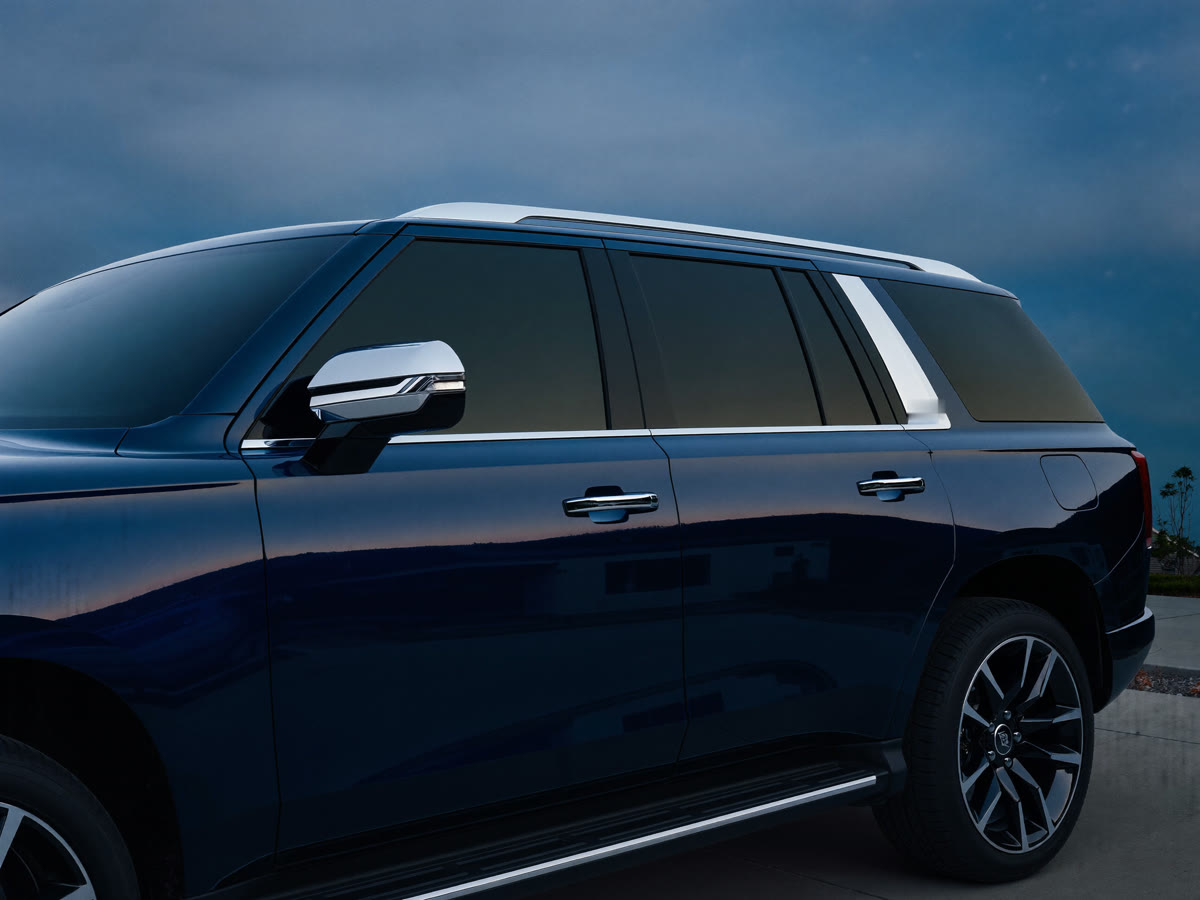 Midnight blue SUV gleaming on a driveway at dusk